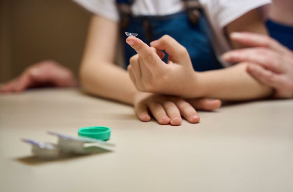 A child holding a MiSight Contact lense to help with their myopia progression