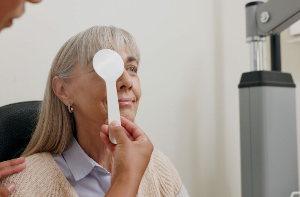 Older woman undergoing a vision test at an eye clinic.
